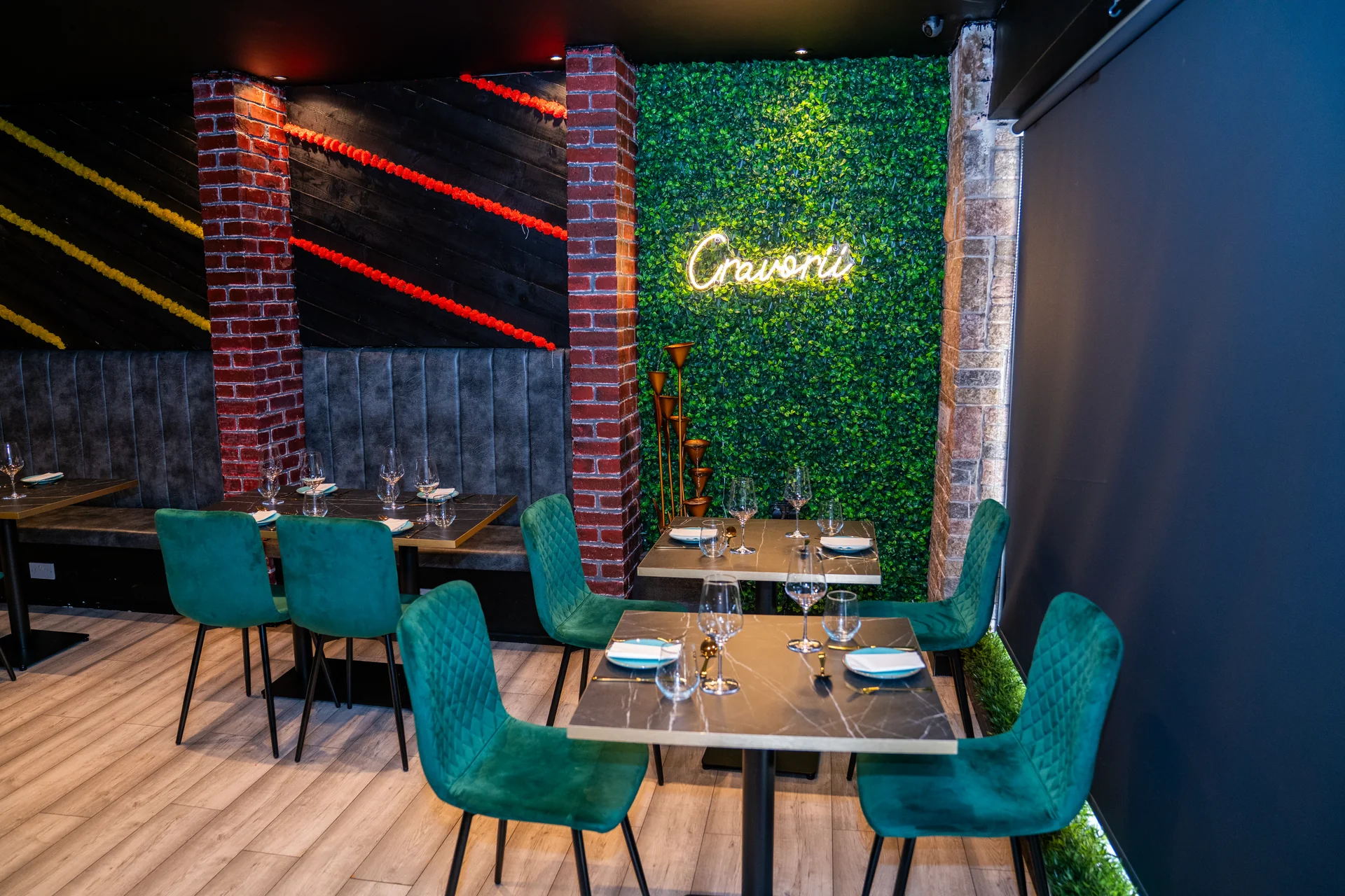 Cravorii intimate dining room with neon sign